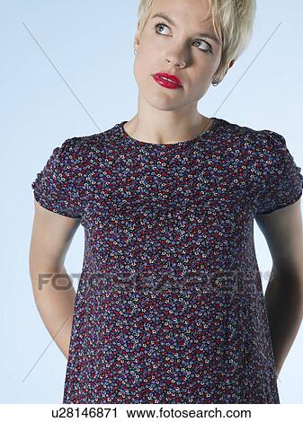 Stock Image - Young woman looking up. Fotosearch