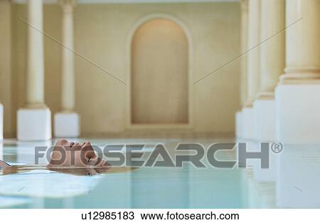Young woman lying on back in swimming pool portrait View Large Photo Image Stock Image - Young woman lying on back in swimming pool portrait. Fotosearch