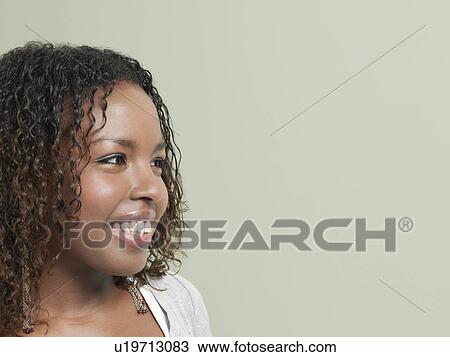 Stock Image - Young woman smiling close-up. Fotosearch