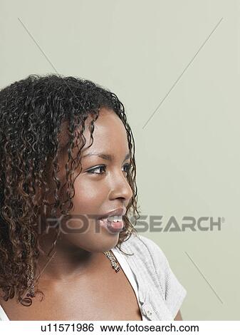 Stock Photograph - Young woman smiling close-up. Fotosearch
