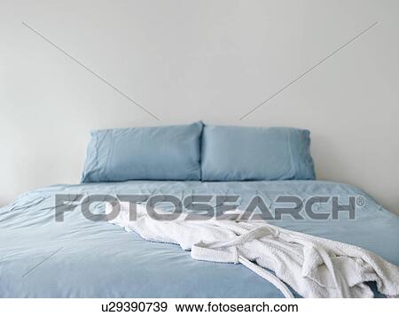 Stock Photo - Bathrobe on bed. Fotosearch