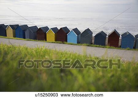 Beach huts lined up along beach back view View Large Photo Image Stock Image - Beach huts lined up along beach back view. Fotosearch