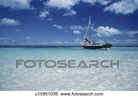 Stock Photo - Boat moored in shallow water Far North Queensland Australia. Fotosearch