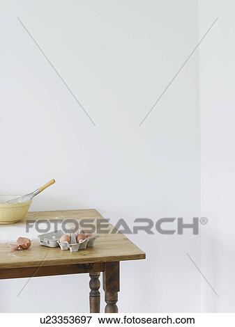 Stock Photo - Bowl eggs and flour scattered on table. Fotosearch