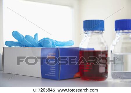 Box of rubber gloves next to chemicals on shelf View Large Photo Image Stock Photography - Box of rubber gloves next to chemicals on shelf. Fotosearch