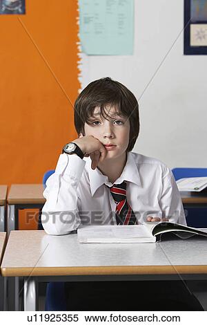 Boy (10-12) wearing shirt and tie in classroom portrait View Large Photo Image Stock Photography - Boy (10-12) wearing shirt and tie in classroom portrait. Fotosearch