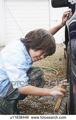 Boy (7-9) washing car wheel with brush View Large Photo Image Stock Photograph - Boy (7-9) washing car wheel with brush. Fotosearch