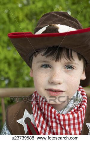 Boy (7-9) wearing cowboy costume portrait close-up View Large Photo Image Stock Photo - Boy (7-9) wearing cowboy costume portrait close-up. Fotosearch