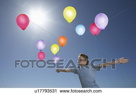 Boy Releasing Balloons View Large Photo Image Stock Image - Boy Releasing Balloons. Fotosearch