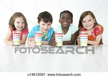 Boys and three girls (5-6) sitting at table holding colourful glasses smiling portrait View Large Photo Image Stock Photo - Boys and three girls (5-6) sitting at table holding colourful glasses smiling portrait. Fotosearch