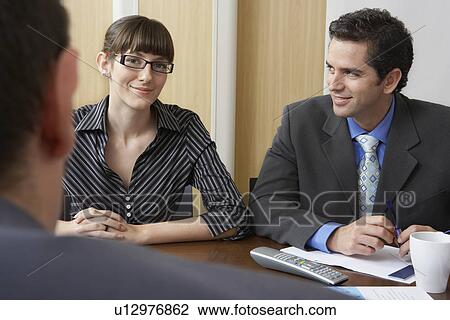 Business colleagues in office meeting View Large Photo Image Stock Image - Business colleagues in office meeting. Fotosearch