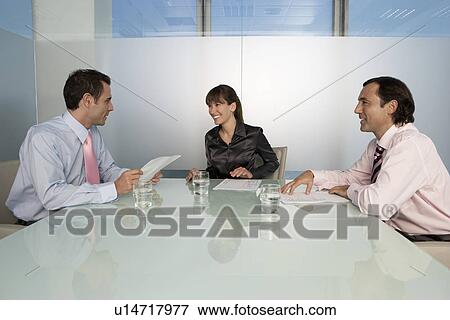 Business colleagues in office meeting View Large Photo Image Stock Photo - Business colleagues in office meeting. Fotosearch