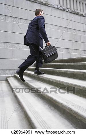 Business man carrying briefcase ascending steps View Large Photo Image Stock Image - Business man carrying briefcase ascending steps. Fotosearch