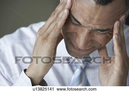 Business man holding head in hands close up elevated view View Large Photo Image Stock Image - Business man holding head in hands close up elevated view. Fotosearch