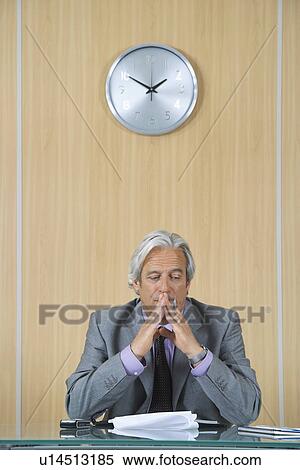 Business man reading papers in office View Large Photo Image Stock Photography - Business man reading papers in office. Fotosearch