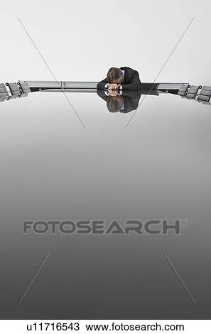 Business man resting at table in conference room View Large Photo Image Stock Image - Business man resting at table in conference room. Fotosearch
