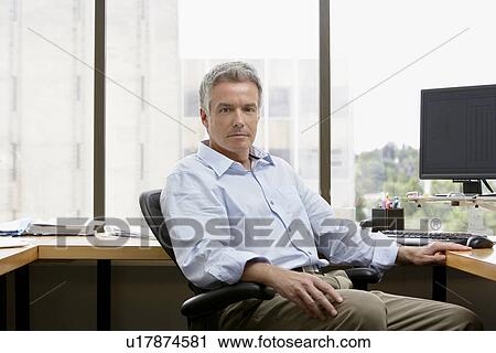 Business man sitting in office View Large Photo Image Stock Image - Business man sitting in office. Fotosearch