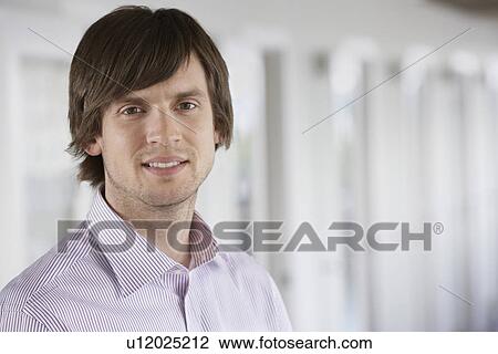 Business man smiling indoors portrait View Large Photo Image Stock Image - Business man smiling indoors portrait. Fotosearch