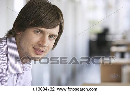 Business man smiling indoors portrait View Large Photo Image Stock Image - Business man smiling indoors portrait. Fotosearch