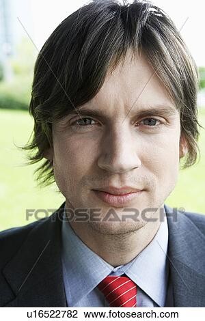 Stock Image - Business man smiling outdoors close-up portrait. Fotosearch