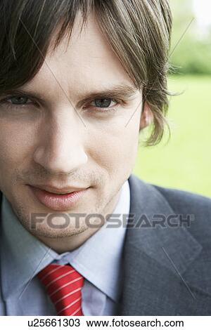 Stock Image - Business man smiling outdoors close-up portrait. Fotosearch