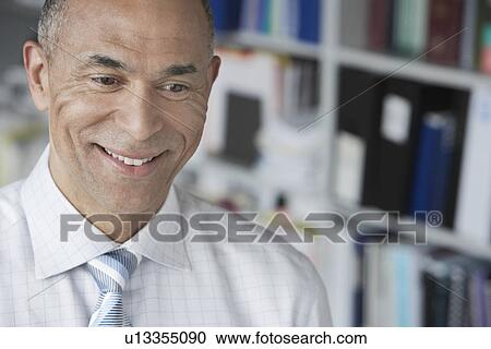 Business man standing in office elevated view portrait View Large Photo Image Stock Image - Business man standing in office elevated view portrait. Fotosearch