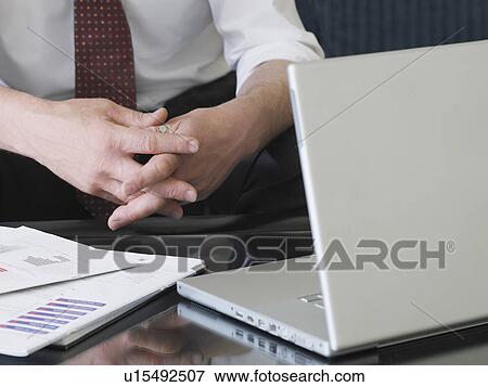 Business man using laptop sitting on sofa mid section close-up of hands View Large Photo Image Stock Photo - Business man using laptop sitting on sofa mid section close-up of hands. Fotosearch