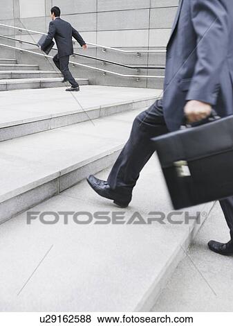 Business men hurrying up steps outdoors side view View Large Photo Image Stock Photo - Business men hurrying up steps outdoors side view. Fotosearch