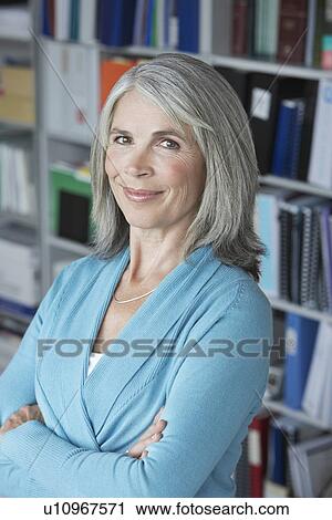 Stock Image - Business woman in office elevated view portrait. Fotosearch