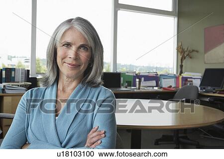 Stock Image - Business woman in office portrait. Fotosearch