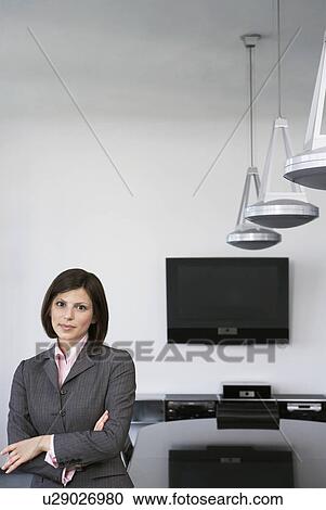 Business woman leaning against table in conference room portrait View Large Photo Image Stock Image - Business woman leaning against table in conference room portrait. Fotosearch
