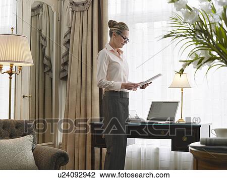 Business woman reading document in home office side view View Large Photo Image Stock Image - Business woman reading document in home office side view. Fotosearch