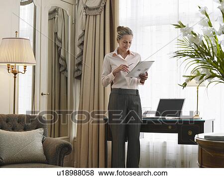 Business woman reading document in home office View Large Photo Image Stock Photo - Business woman reading document in home office. Fotosearch