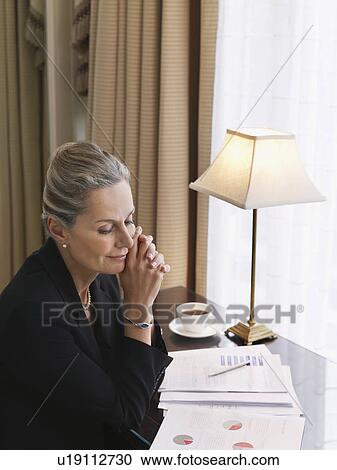 Business woman sitting at desk elevated view View Large Photo Image Stock Image - Business woman sitting at desk elevated view. Fotosearch