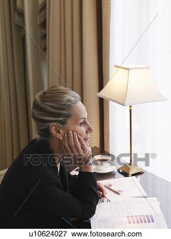 Business woman sitting at desk elevated view side view View Large Photo Image Stock Photo - Business woman sitting at desk elevated view side view. Fotosearch
