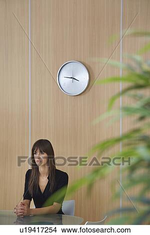 Picture - Business woman sitting at table in conference room. Fotosearch