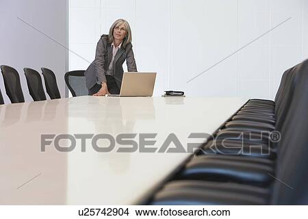 Business woman using laptop in board room View Large Photo Image Picture - Business woman using laptop in board room. Fotosearch