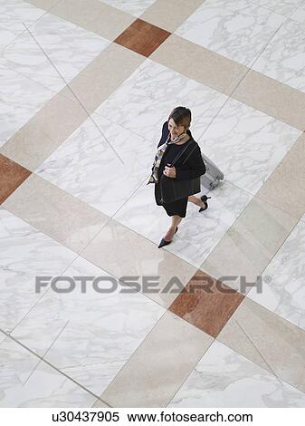 Business woman walking with suitcase elevated view View Large Photo Image Stock Photography - Business woman walking with suitcase elevated view. Fotosearch