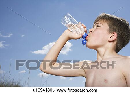 Stock Photography - By (10-12) drinking from water bottle side view. Fotosearch