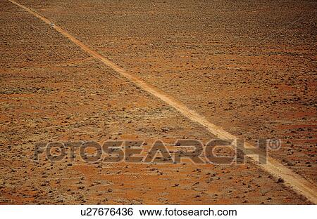 Car driving along desert road outback Australia View Large Photo Image Stock Photograph - Car driving along desert road outback Australia. Fotosearch