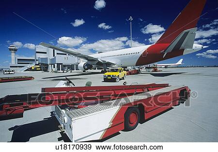 Stock Photo - Cart near aeroplane at airport Perth Australia. Fotosearch