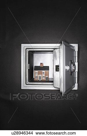 Picture - Ceramic house in opened safe. Fotosearch