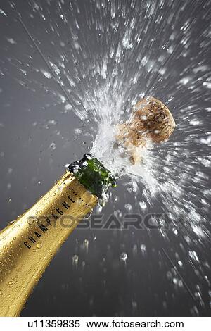 Champagne bottle popping cork close-up View Large Photo Image Stock Photography - Champagne bottle popping cork close-up. Fotosearch