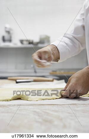 Chef preparing dough in kitchen View Large Photo Image Picture - Chef preparing dough in kitchen. Fotosearch