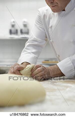Chef preparing dough in kitchen View Large Photo Image Stock Image - Chef preparing dough in kitchen. Fotosearch