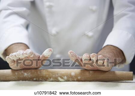Chef rolling dough using rollingpin close-up View Large Photo Image Stock Image - Chef rolling dough using rollingpin close-up. Fotosearch