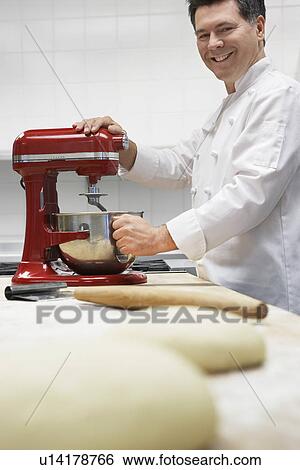 Chef using dough mixer in kitchen portrait View Large Photo Image Stock Photograph - Chef using dough mixer in kitchen portrait. Fotosearch