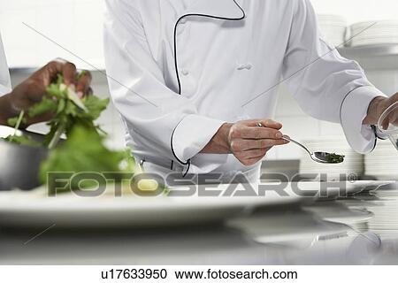 Chefs preparing salad in kitchen mid section View Large Photo Image Stock Image - Chefs preparing salad in kitchen mid section. Fotosearch