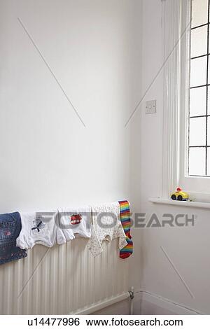 Child's clothing drying on radiator View Large Photo Image Stock Photograph - Child's clothing drying on radiator. Fotosearch