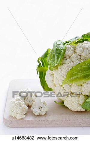 Close-up of cauliflower on cutting board View Large Photo Image Stock Image - Close-up of cauliflower on cutting board. Fotosearch